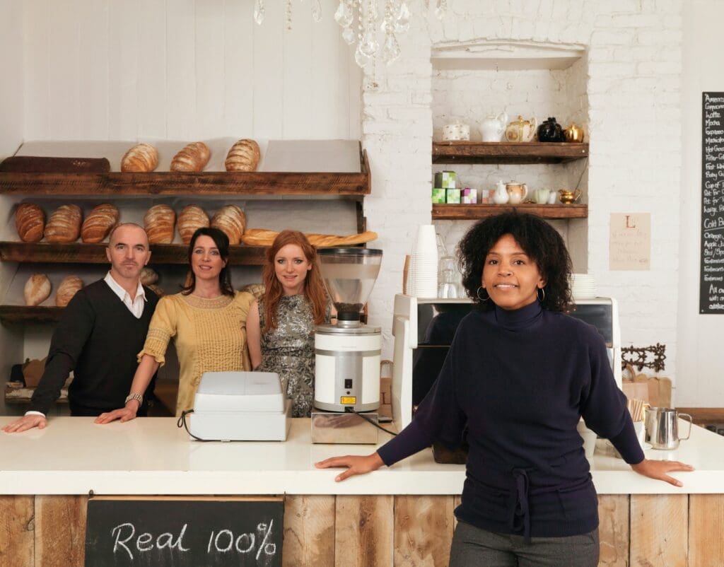 Business owner posing with employees